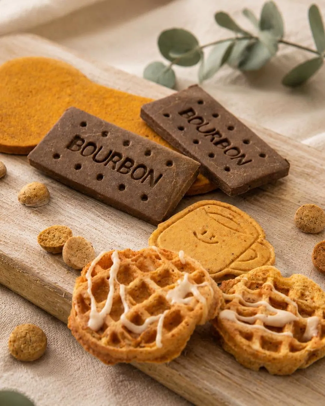 WORTH bourbon biscuits, waffle bakes and training treats on a wooden board